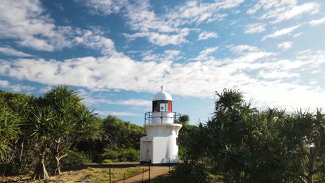 vista única de un faro de estilo colonial encaramado en un enclave escénico con un fondo de cielo azul nublado