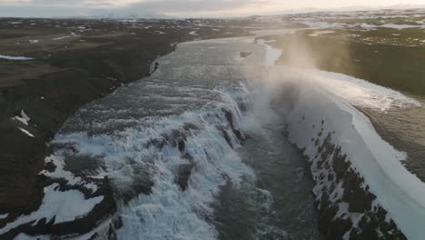 Mist-from-Gullfoss-Falls-Waterfall-in-Iceland-during-Beautiful-Sunset,-Aerial