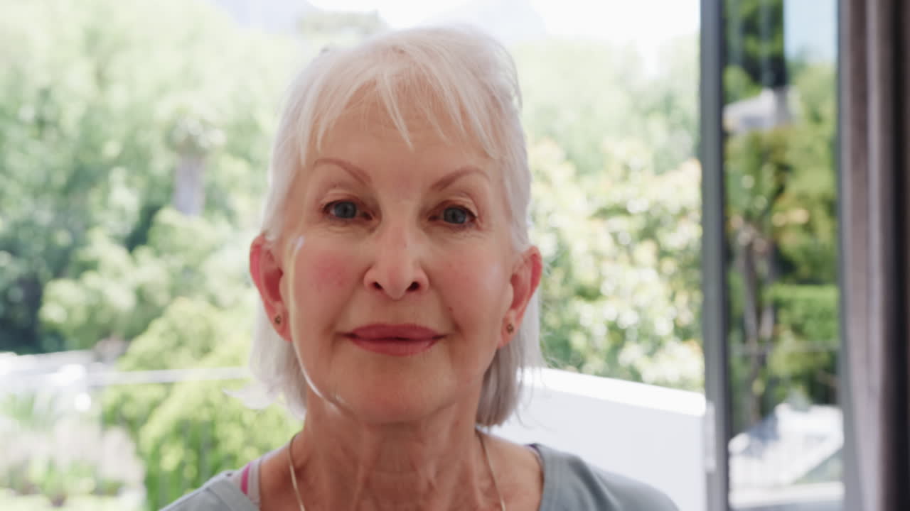 Senior woman enjoying peaceful moment at home, surrounded by lush greenery, at home