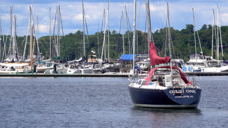 a sailboat pulls at its moors in harbor