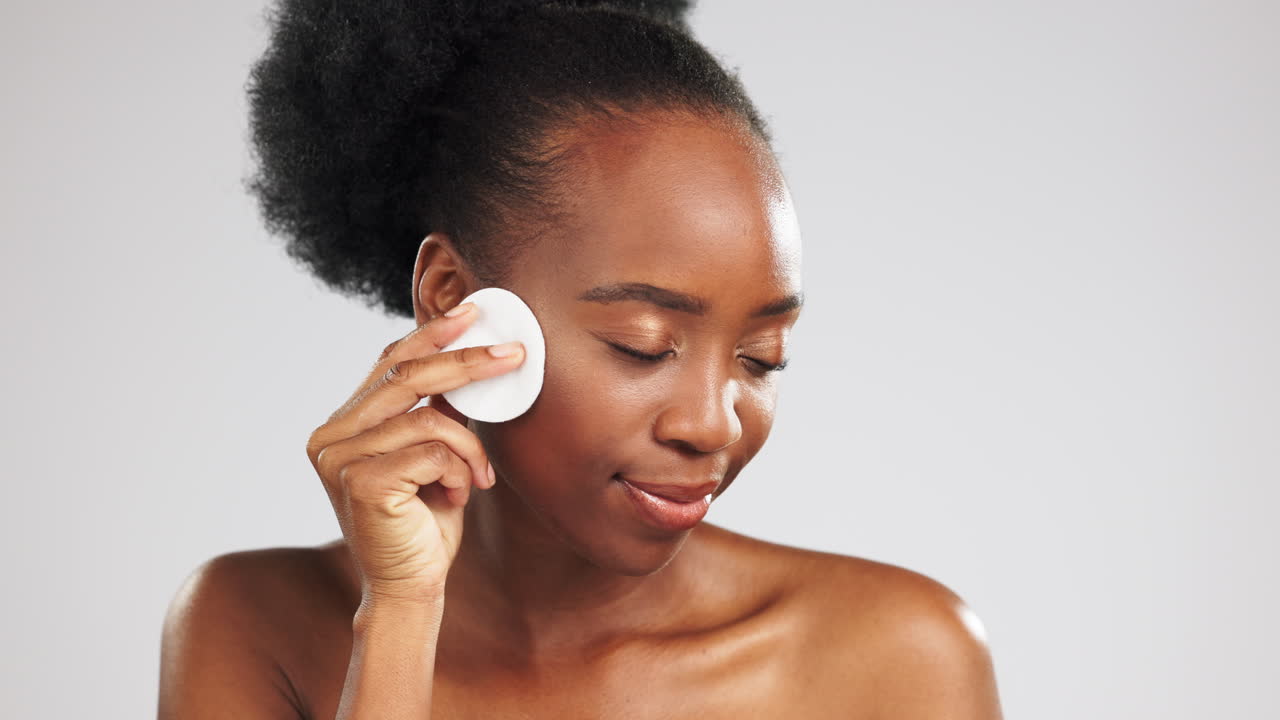Face, skincare and black woman with cotton