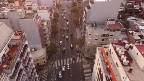 dynamic movement of cars in perfect lanes amidst tall buildings on cordoba avenue in buenos aires, argentina