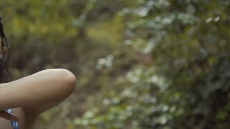 in this shot, an indian woman's arm takes center stage against a softly blurred forest background