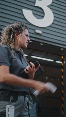 logistics worker using a tablet at a delivery hub