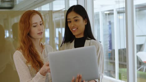 female executives discussing over laptop 4k