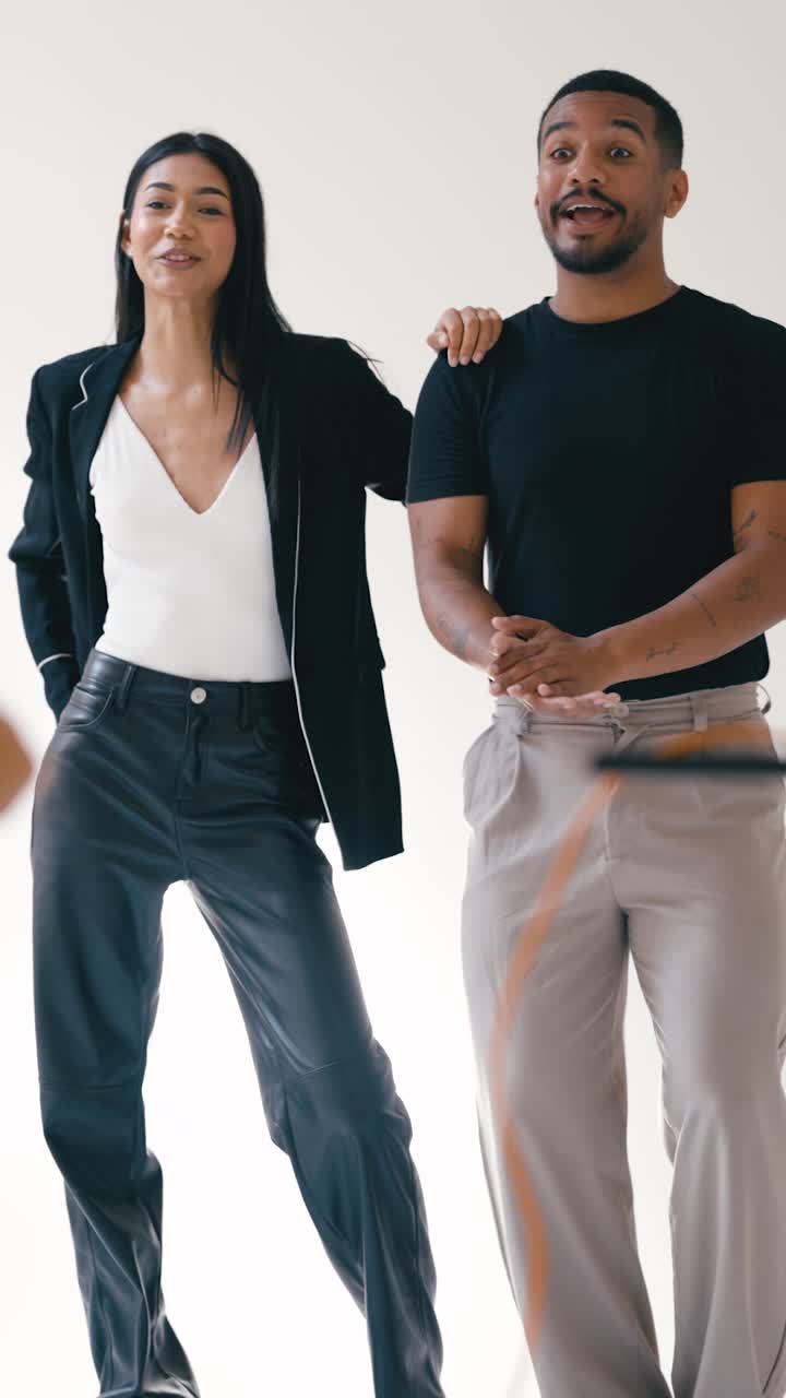 Two people in business casual attire posing for a studio shot
