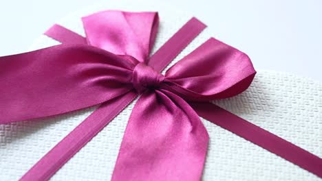 pink ribbon on a heart-shaped gift box