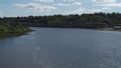 Aerial-view-over-the-River-Medway,-with-a-rising-reveal-of-Rochester-Castle,-Cathedral---Town