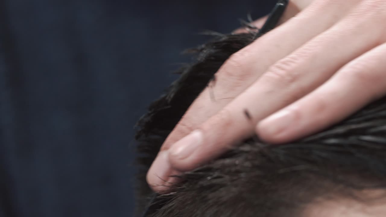 Close-up of a Barber Cutting Hair