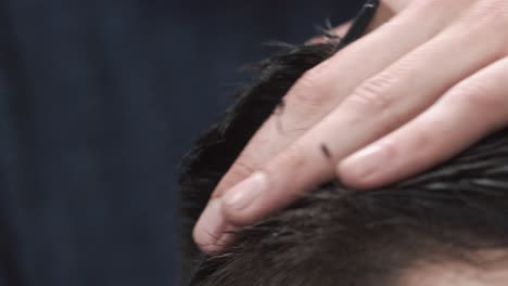 close-up of a barber cutting hair
