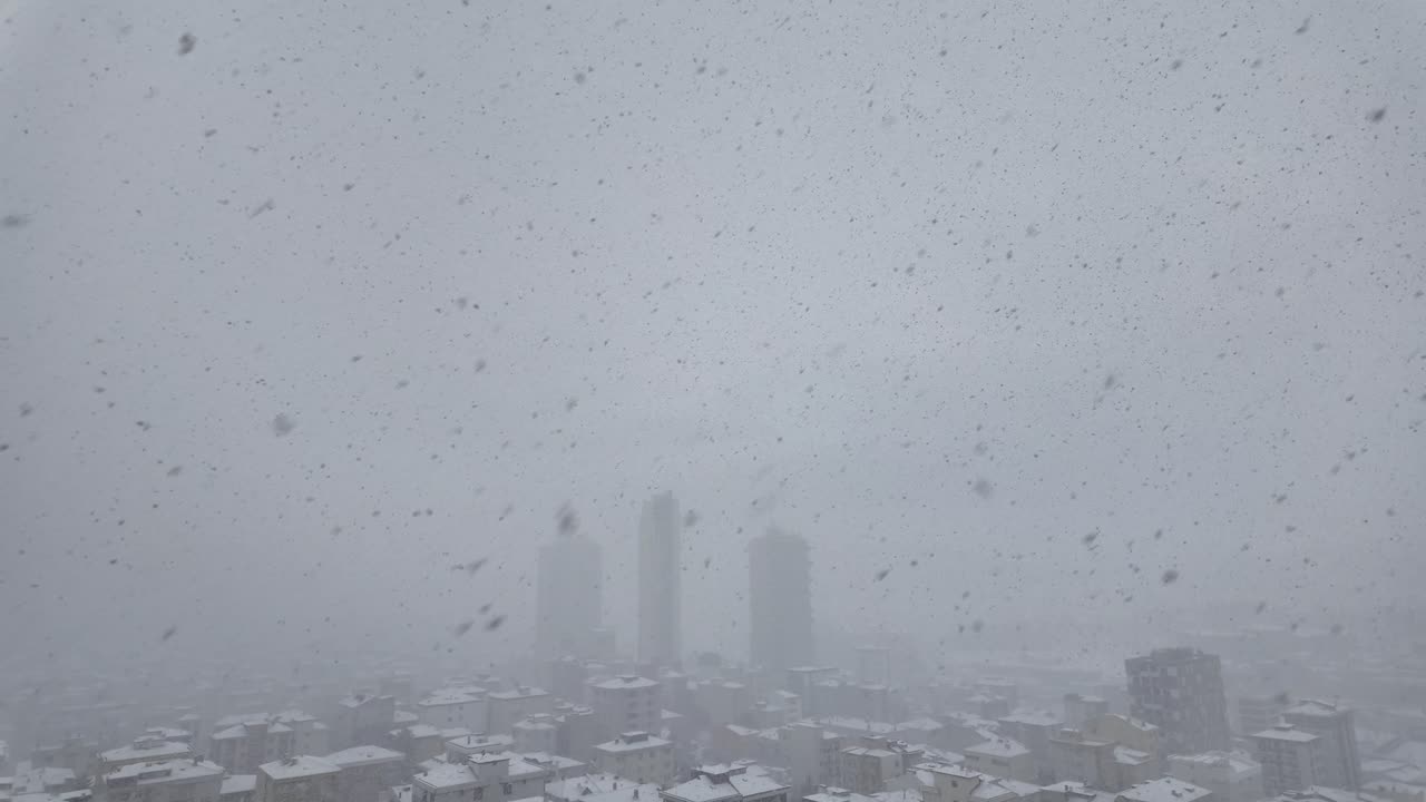 Heavy Snowfall Over a Cityscape in Winter