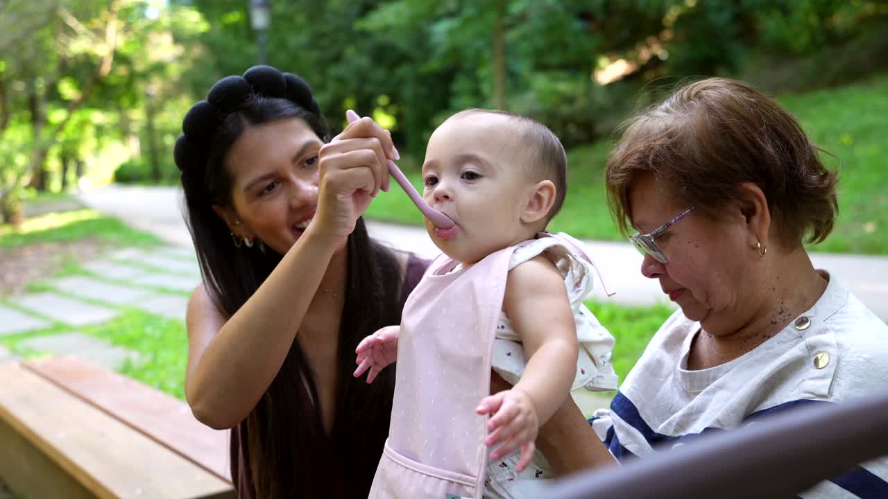 Family Feeding Baby in the Park