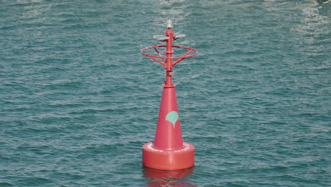 sea mark, red buoy floating in the sea with calm waves at daytime in tokyo, japan