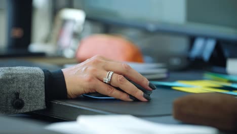 close up of corporate business lady with expensive ring mouse scrolling in a office enviroment