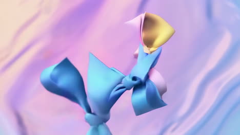 floating pastel bows on iridescent fabric background
