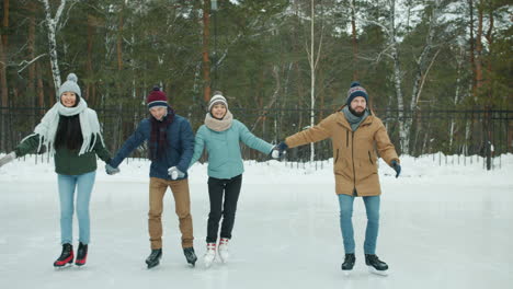 friends ice skating in winter park