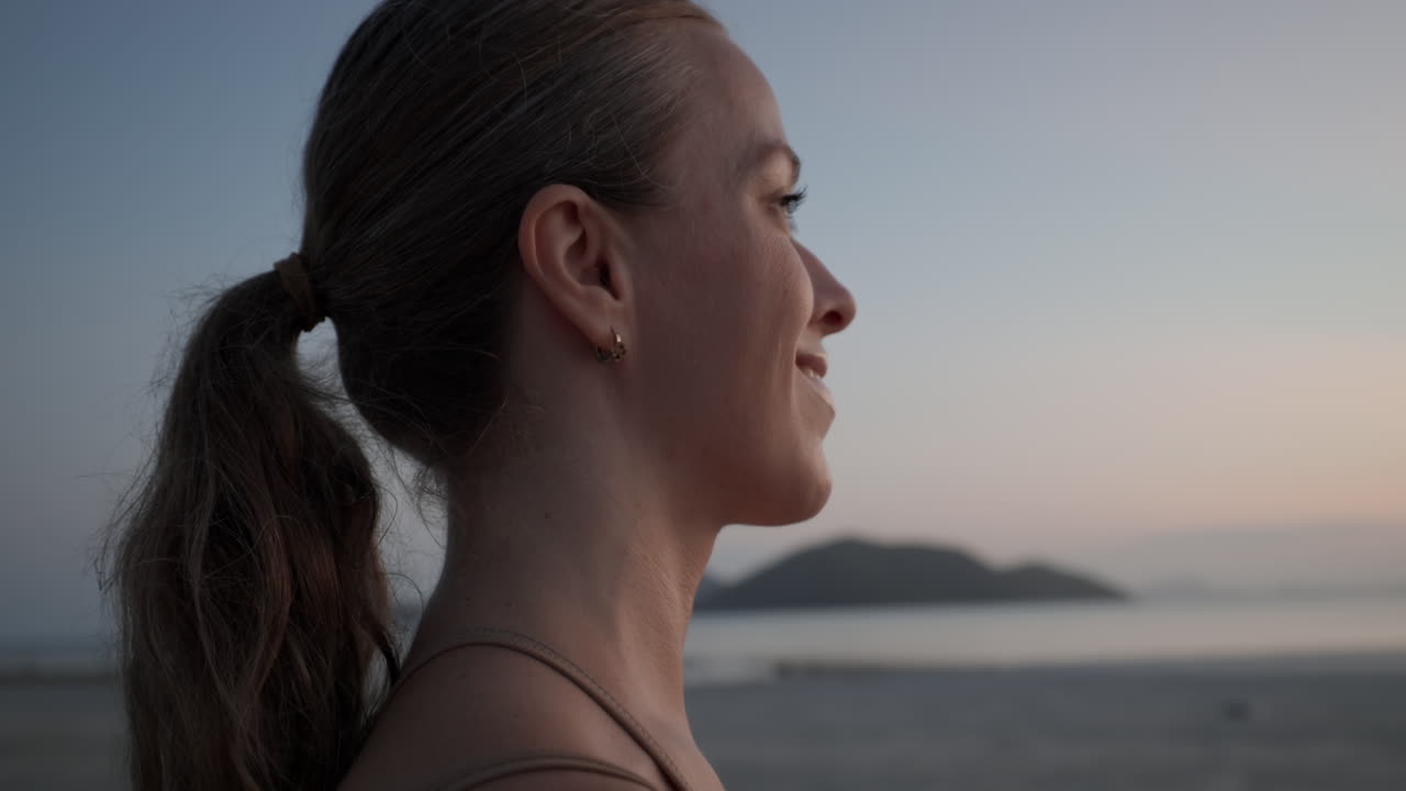 Peaceful Young Woman Looking at the Horizon by the Sea
