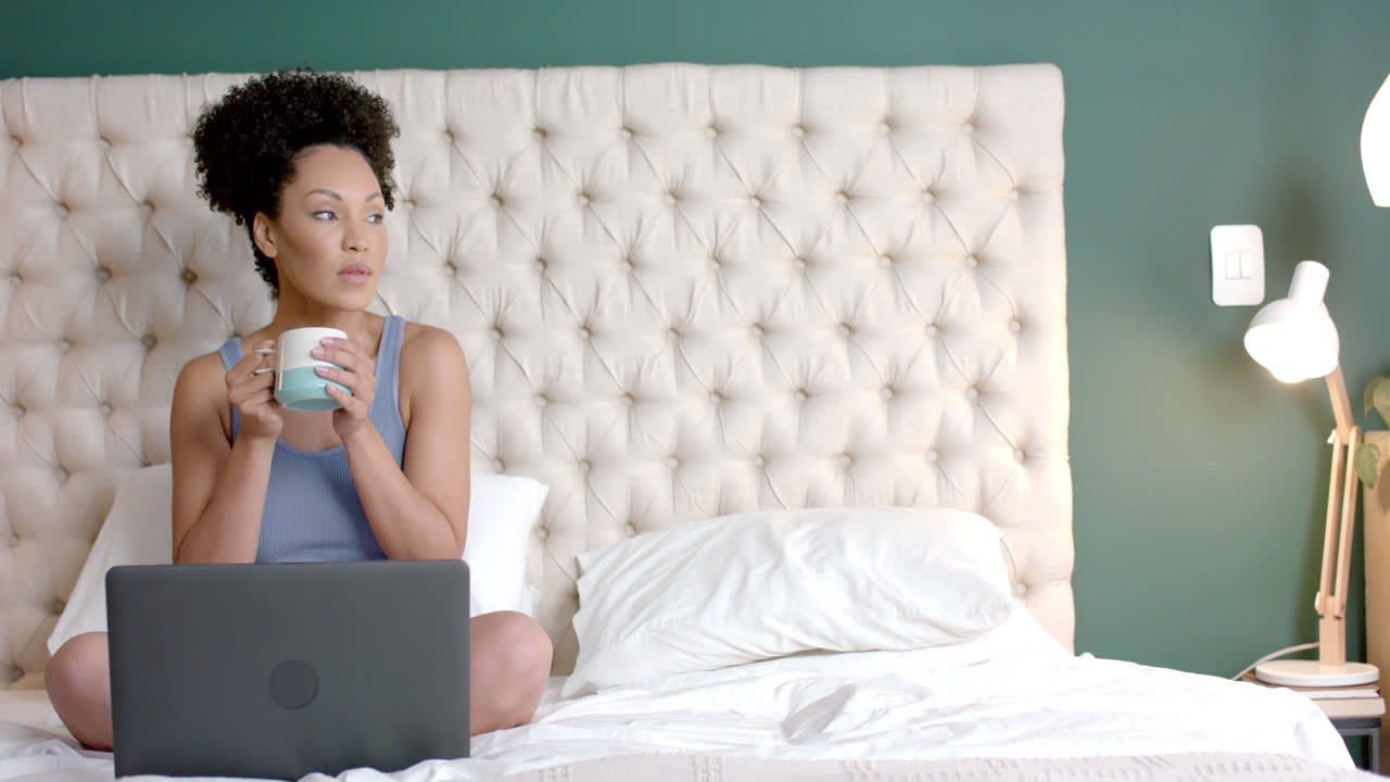 Montage of biracial woman using laptop and smartphone at home, slow motion