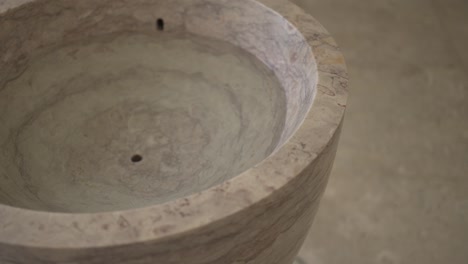 marble baptismal font with detailed texture, symbolizing purity and renewal