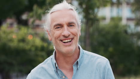 slow motion portrait of happy mature caucasian man smiling