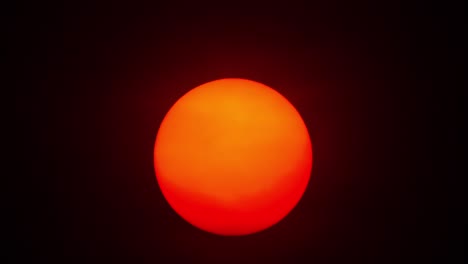 red sun sphere in thick smog