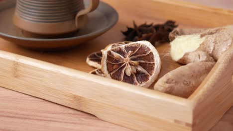 ginger lemon tea with spices on a wooden tray