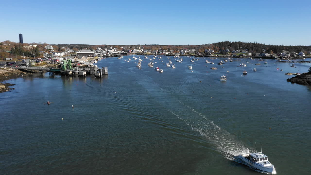 Aerial Fly Over Drone Footage showing boat leaving Vinalhaven, Fox Islands, Knox County, Maine USA