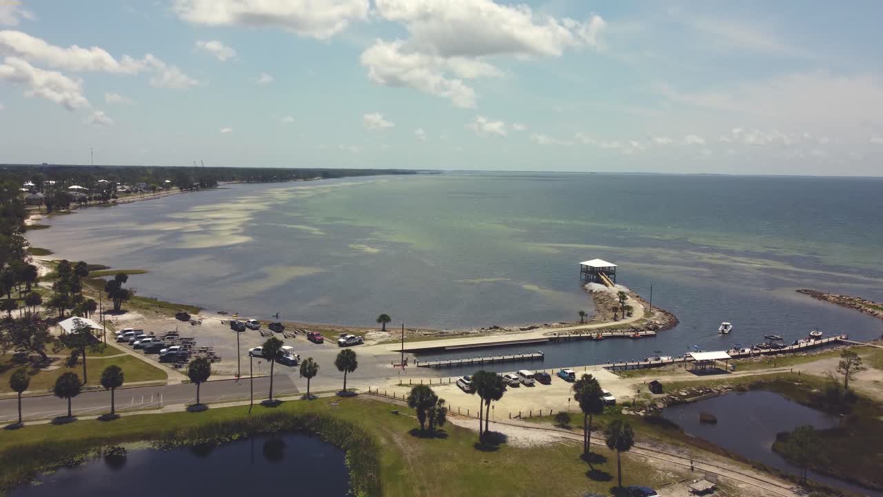 Beautiful aerial footage of a sunny harbor in a popular vacation destination in Florida during a clear summer day.