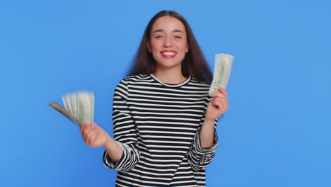 happy rich woman holding fan of cash money dollar banknotes celebrate win dancing success business