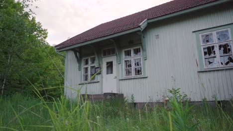 Abandoned-house-with-broken-windows.-Overgrown-yard