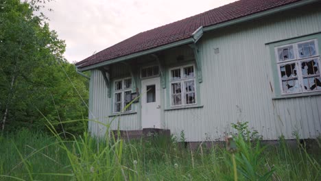 abandoned house with broken windows. overgrown yard