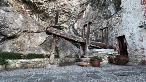 Big-old-wooden-wine-press-at-the-hermitage-of-Santa-Caterina-del-Sasso-in-Leggiuno,-Italy