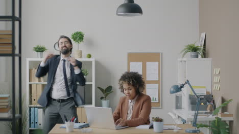 dancing colleagues in office