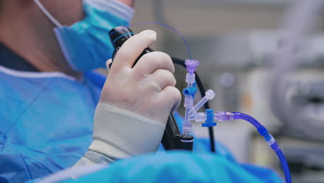 surgeon work with innovative equipment. doctor's hand holds modern equipment while perform an operation. close-up.