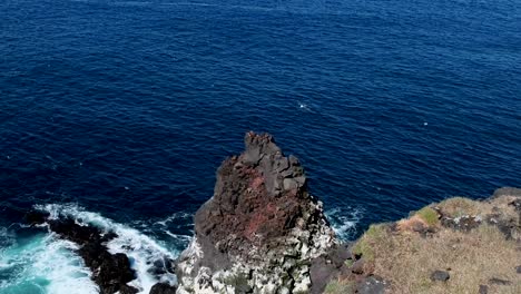 waves crashing on basalt rock by the sea in snaefellsnes peninsula, iceland