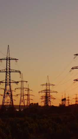 wire electrical energy at sunset. high voltage electricity pole at sunset. vertical video
