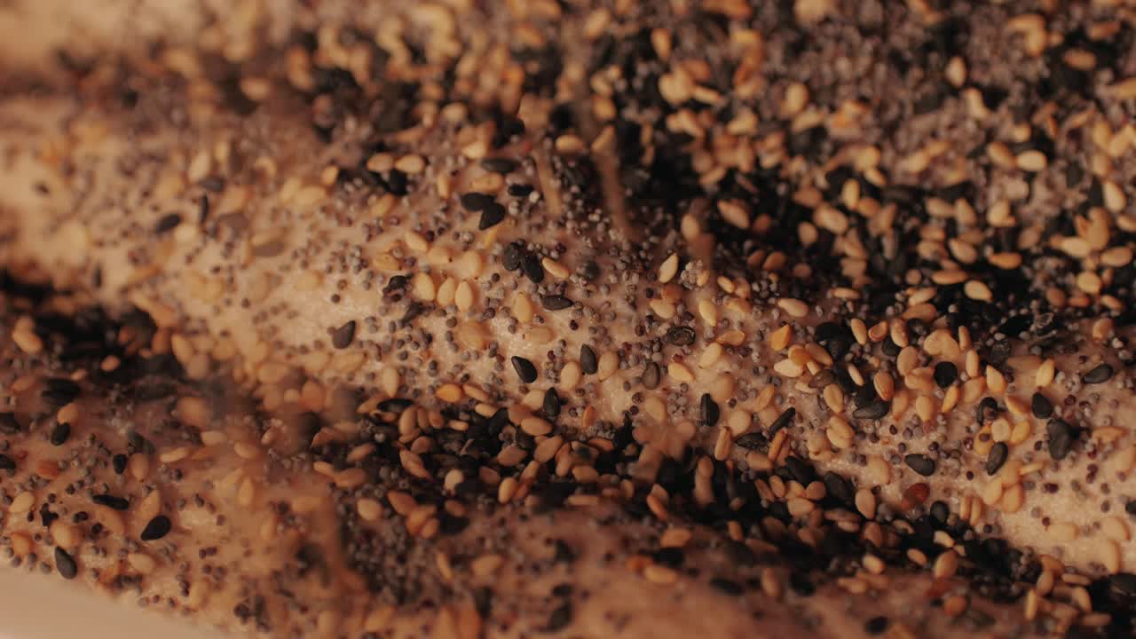 Bakery chef making fresh Artesian buns and baguettes using traditional recipe close-up. Young man kneading dough. Artisan bread is making by skill bakers using natural and high-quality ingredients. Food with health and flavour benefits. Bakery shop and market