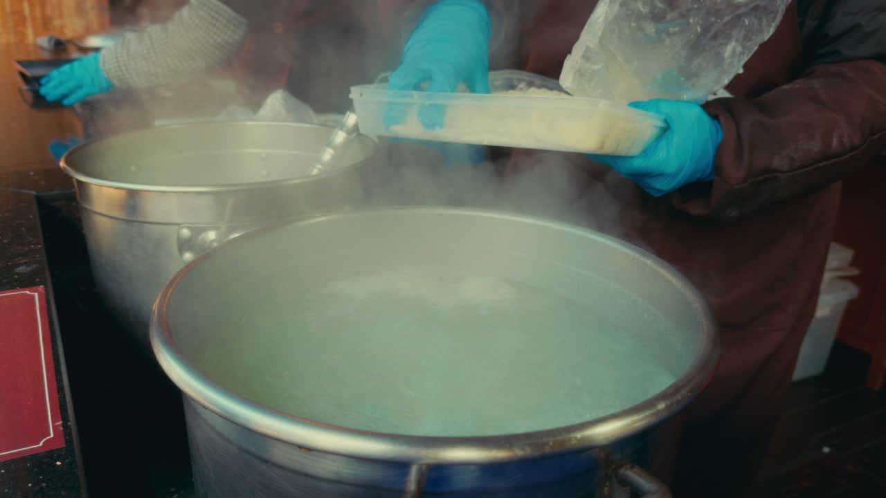 Preparing Hot Food at a Street Food Stall