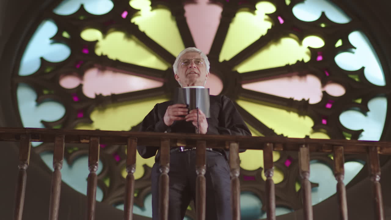 Aged Priest Preaching Sermon in Christian Church