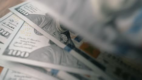 100 dollar bills falling on top of each other extreme close-up shot