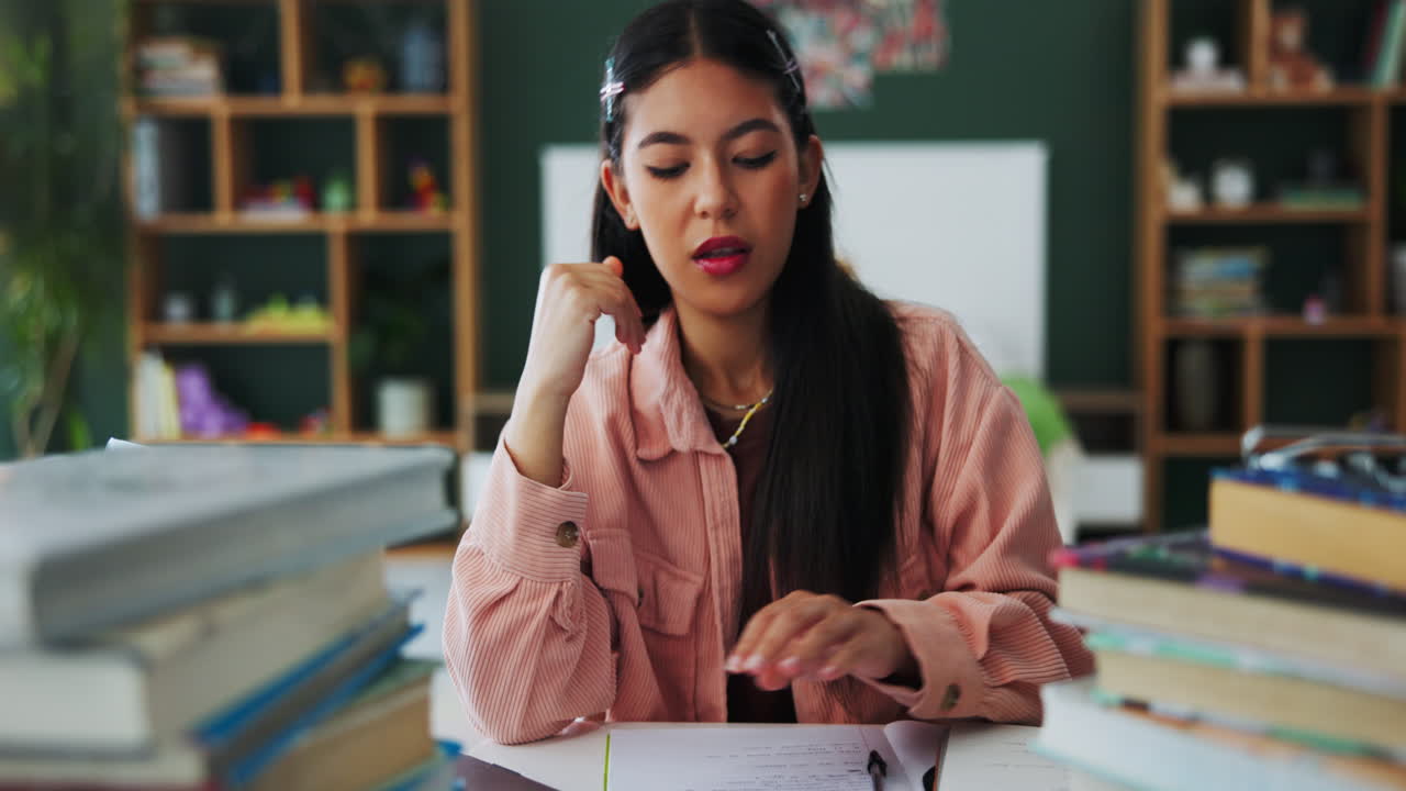 Tired student with books on desk