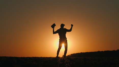 man celebrating at sunset