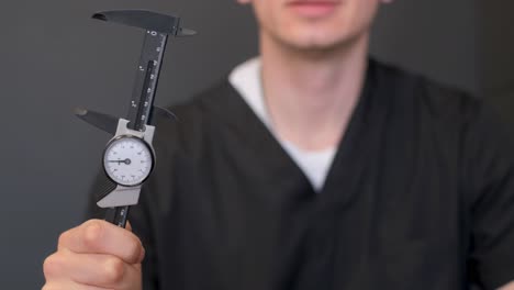 man holding a caliper
