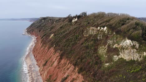 forward aerial shot of the cliffs at branscombe looking towards sidmouth devon england uk