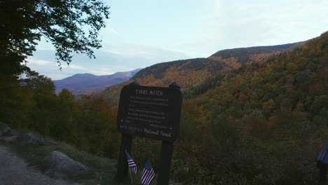 New-England-Fall-Foliage-Drone-Flight-over-Evans-Notch-sign-at-sunrise