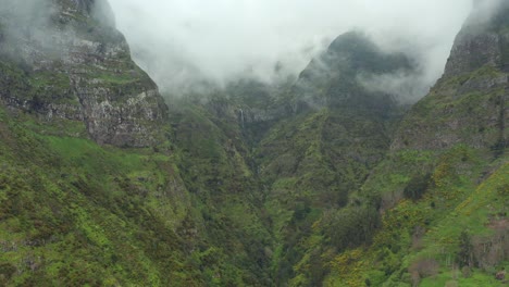 Aerial-shot-of-a-big-waterfall-in-the-mountains-of-Madeira,-Portugal