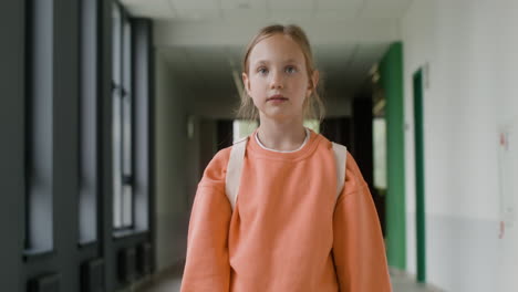 Schoolgirl-walking-through-school-corridor.