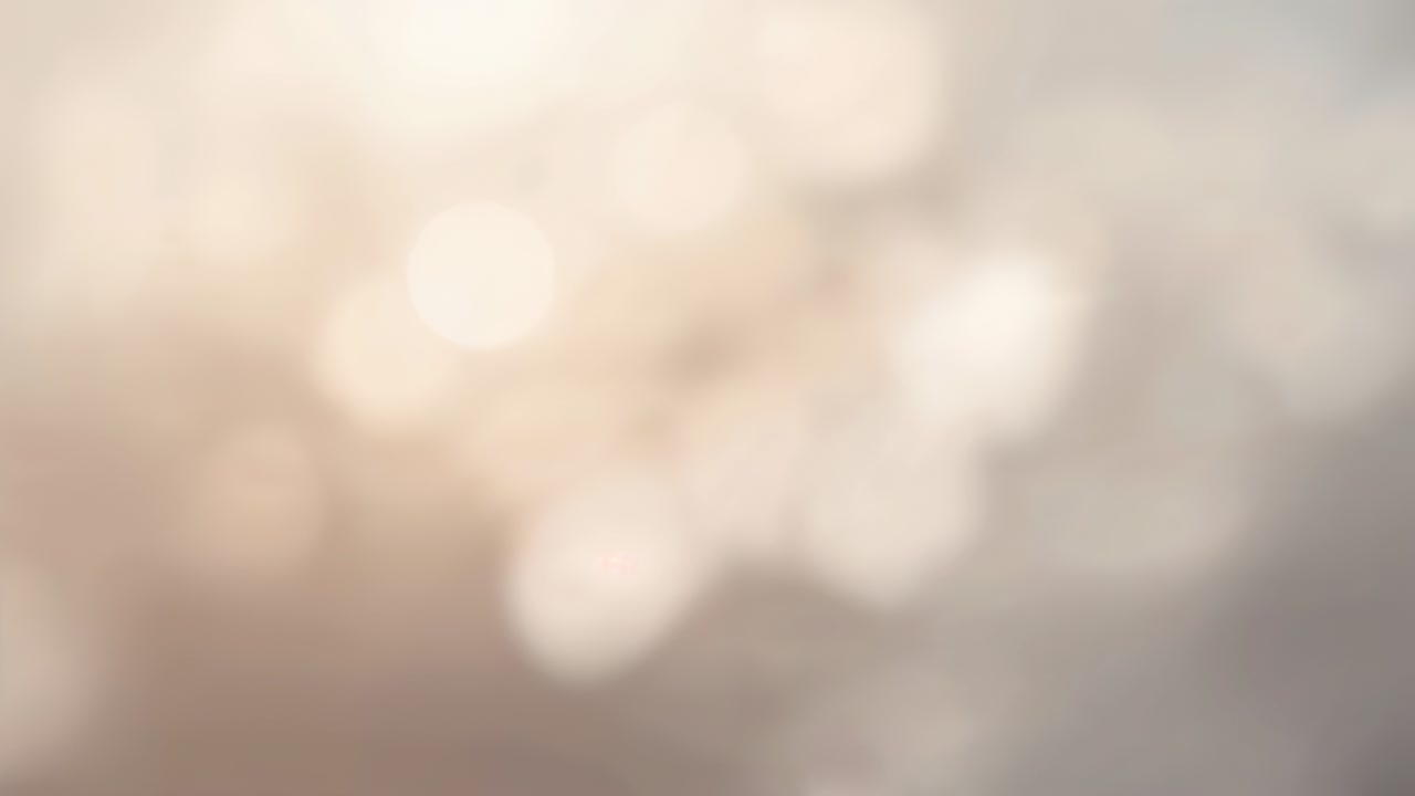 Camera focus shifting, bokeh cluster drifting across abstract soft background, revealing large disc