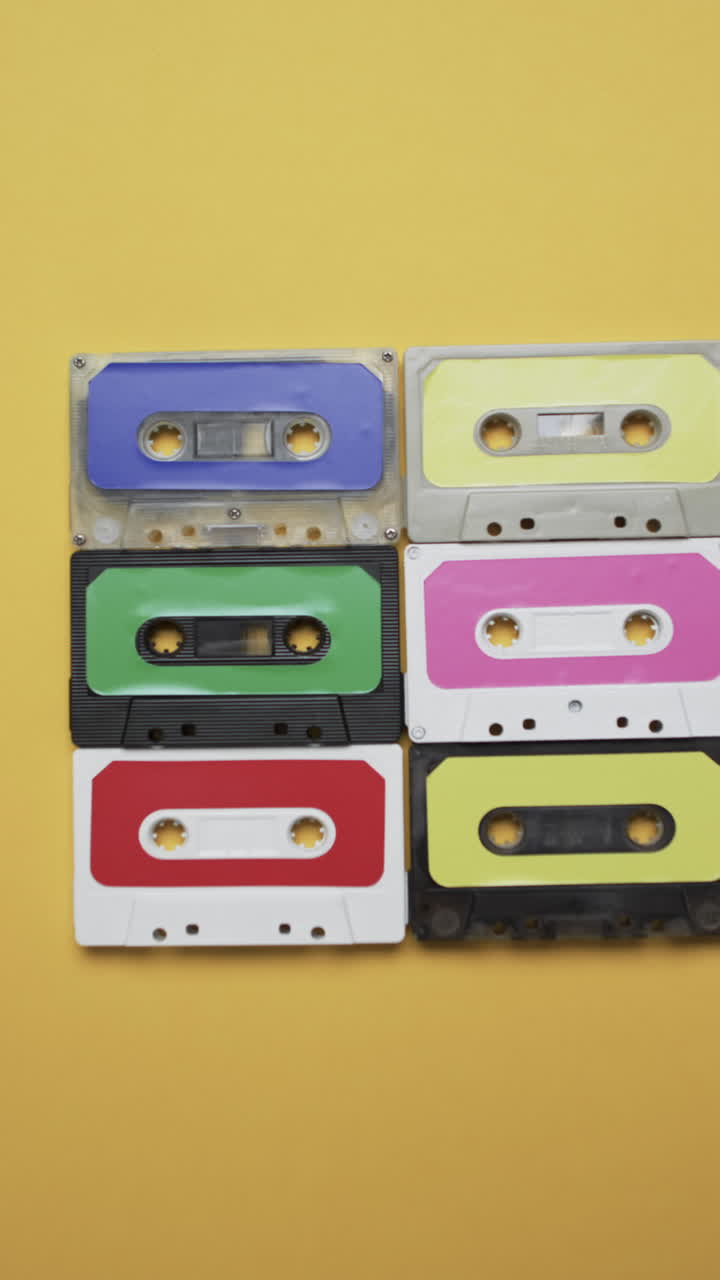 Vertical video of retro tapes with copy space on yellow background