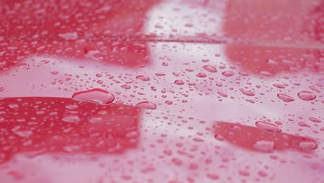 water drops falling on the hood of a car